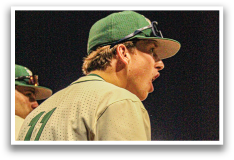 A baseball player wearing a green and white uniform is talking on the field. AI generated content