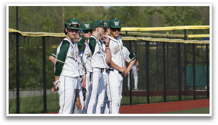 A group of baseball players wearing green and white uniforms stand on a baseball field. AI generated content
