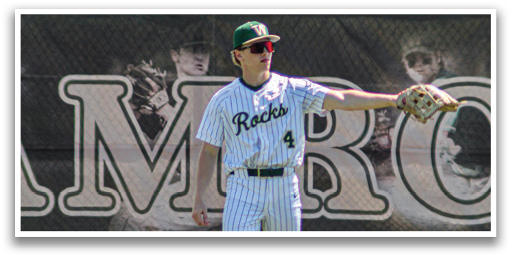 A baseball player wearing a white and black uniform stands on a field, holding a baseball glove. AI generated content