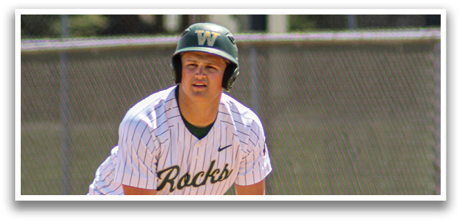 A baseball player in a green and white uniform is crouching on the field, wearing a helmet and holding a baseball bat. AI generated content