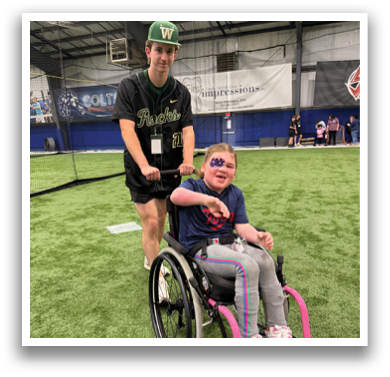 A young girl in a wheelchair is being pushed by a man in a green shirt. AI generated content