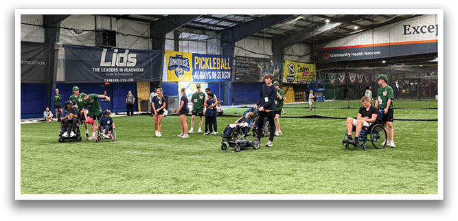 A group of people are standing on a field, some of them are in wheelchairs. AI generated content