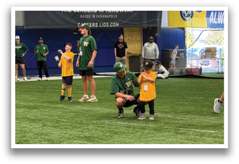 A group of people are standing on a field, some of them wearing green shirts. They are holding baseball bats and are likely preparing for a game. AI generated content