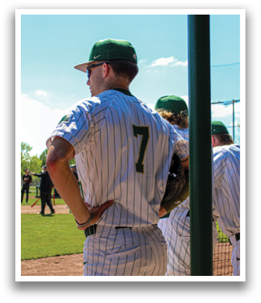 A baseball player wearing a green and white uniform stands on a field. AI generated content