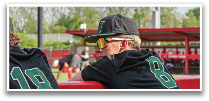 Two baseball players wearing black jerseys with the number 18 on them are sitting on a bench. AI generated content