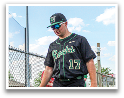A baseball player wearing a black and green jersey walks on the field. AI generated content