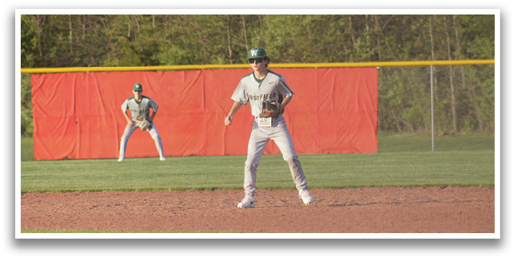A group of baseball players on a field, one of them is wearing a green helmet. AI generated content