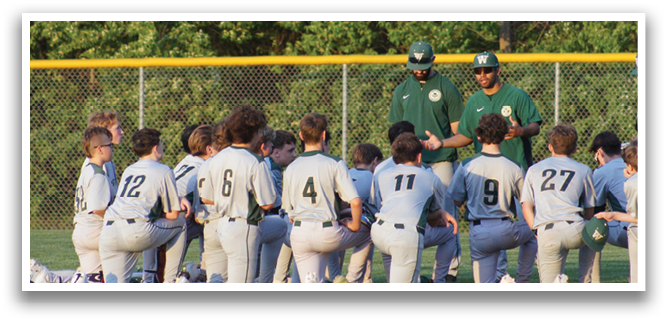 A group of baseball players are sitting on the grass, listening to their coaches. AI generated content