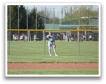 A baseball player in a grey uniform is standing on a baseball field, holding a bat and getting ready to hit a ball. AI generated content