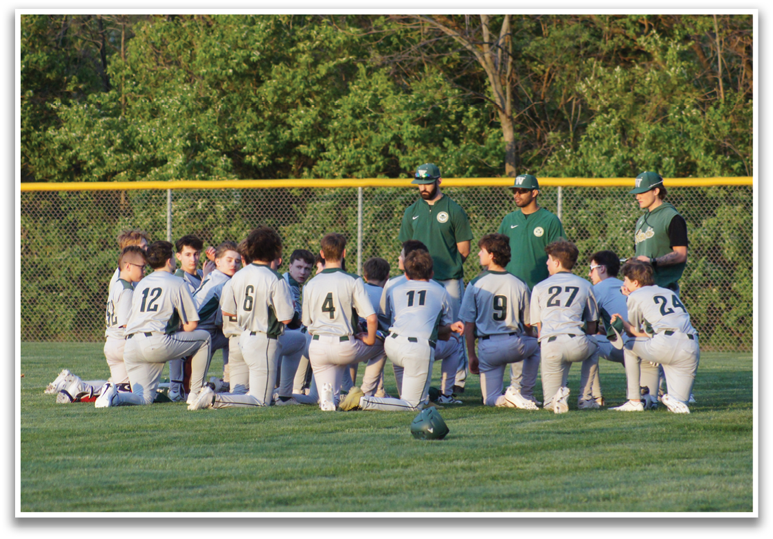 A group of baseball players are kneeling on the grass, with some of them wearing green shirts. AI generated content