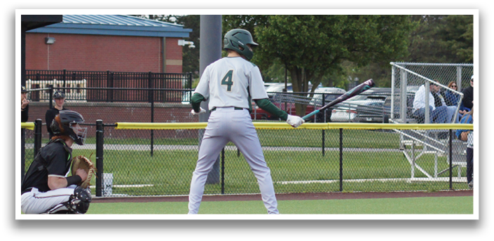 A baseball player wearing a green and white uniform is at bat. Description generated by AI