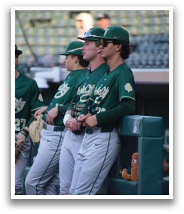Baseball players sitting on bench. Description generated by AI