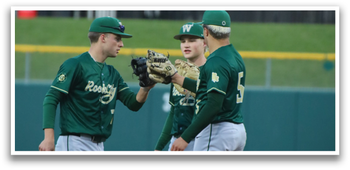 Two baseball players wearing green and white uniforms. Description generated by AI