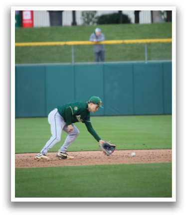 A baseball player is diving for a ball. Description generated by AI