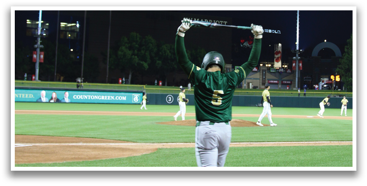 A baseball player holding a bat on a field. Description generated by AI