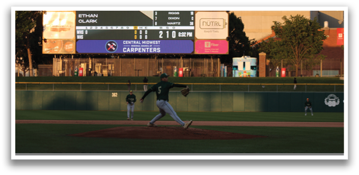 A baseball player is pitching a ball on a field. Description generated by AI