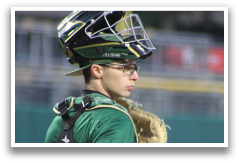A baseball player wearing a green shirt and a baseball glove. Description generated by AI