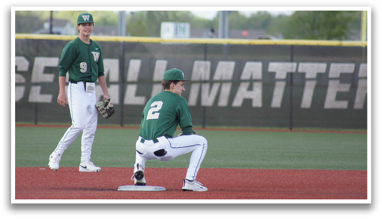 A baseball player kneeling on the ground with a baseball glove. Description generated by AI