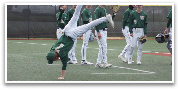 A man is doing a handstand on a baseball field. Description generated by AI