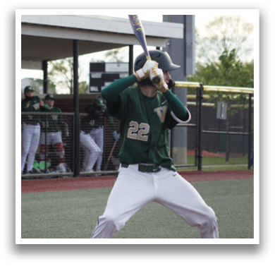 A baseball player is holding a bat and getting ready to hit a ball. Description generated by AI
