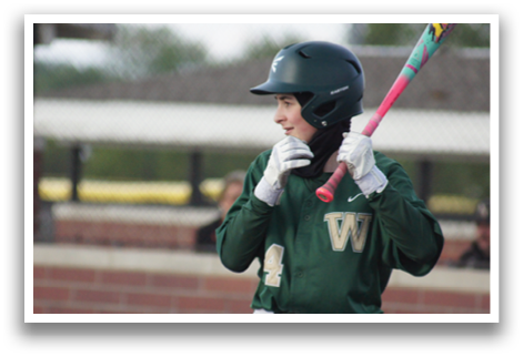 A baseball player holding a bat. Description generated by AI