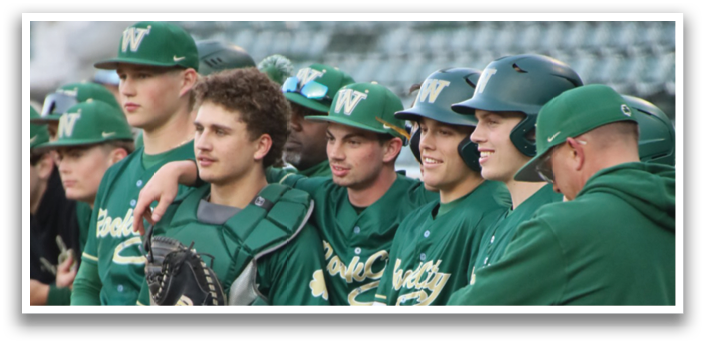 Baseball players in green uniforms. Description generated by AI