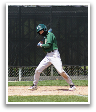 A baseball player in a green shirt is running to a base. Description generated by AI