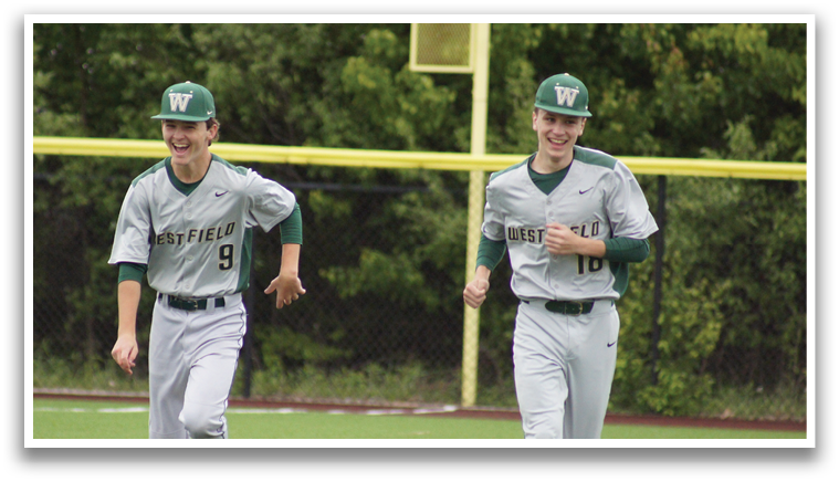 A baseball player wearing a grey uniform with the number 9 on the back. Description generated by AI