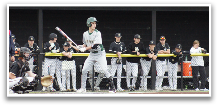 A baseball player is holding a bat and getting ready to hit the ball. Description generated by AI