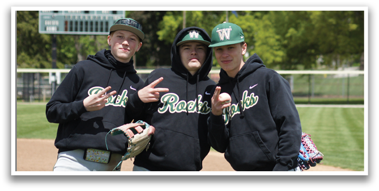 Three men wearing black hoodies and baseball gloves. Description generated by AI