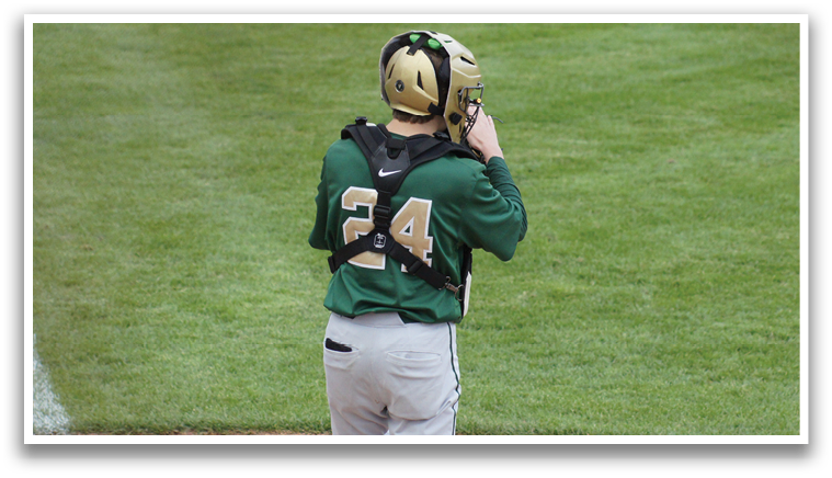 A baseball player wearing a green and white uniform. Description generated by AI
