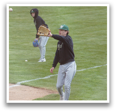 A baseball player wearing a green hat and a black jacket is throwing a baseball. Description generated by AI