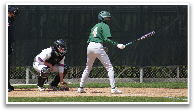 A baseball player is at bat, holding a bat and ready to swing. Description generated by AI