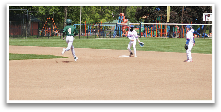 A baseball game is taking place on a field with a player running to the base. Description generated by AI