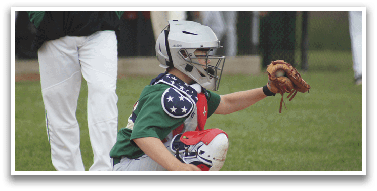 A young boy wearing a baseball glove and a green shirt. Description generated by AI
