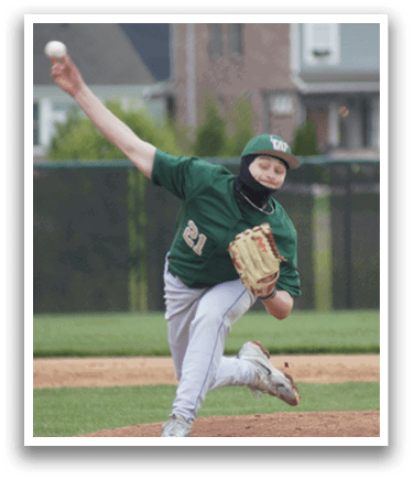 A baseball player in a green shirt and white pants is throwing a ball. Description generated by AI