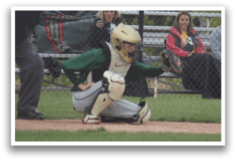 A baseball player is standing at home plate, holding a bat. Description generated by AI