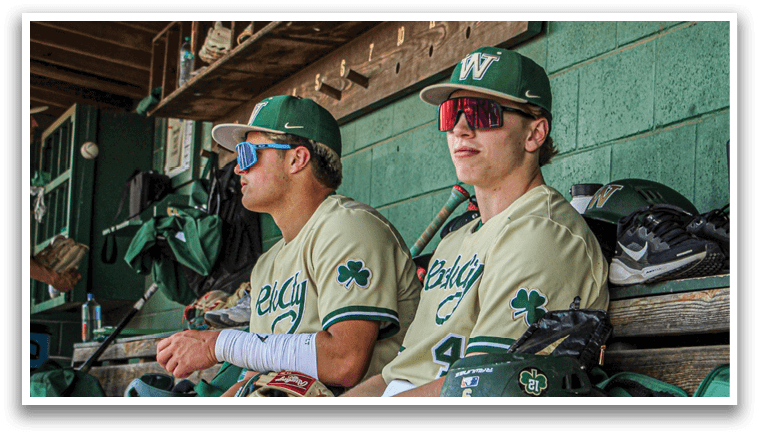 Two baseball players sitting on a bench. Description generated by AI