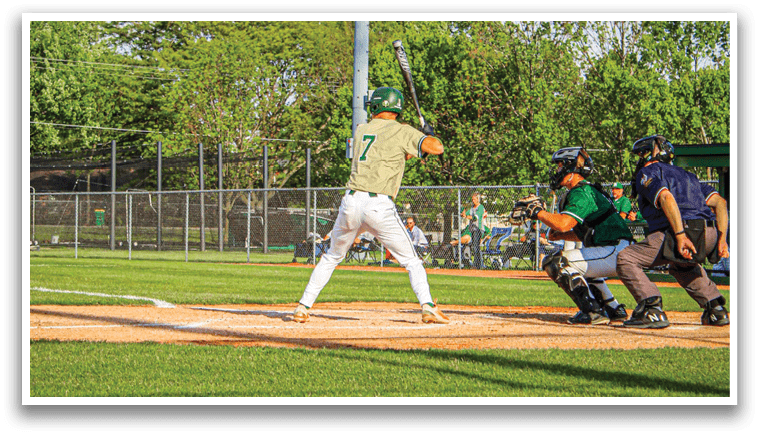 A baseball player is swinging a bat on a field. Description generated by AI