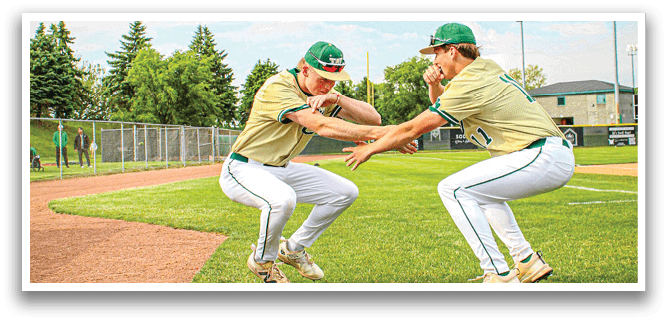 Two men playing baseball on a field. Description generated by AI