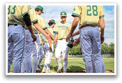 A group of baseball players standing on a field. Description generated by AI