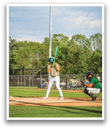 A baseball player is holding a bat and getting ready to hit the ball. Description generated by AI