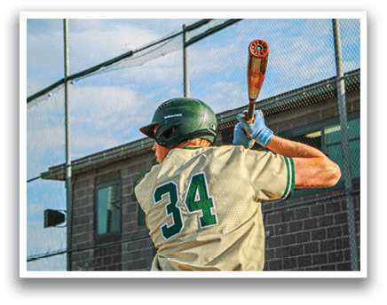 A baseball player in a yellow and green uniform is swinging a bat. Description generated by AI