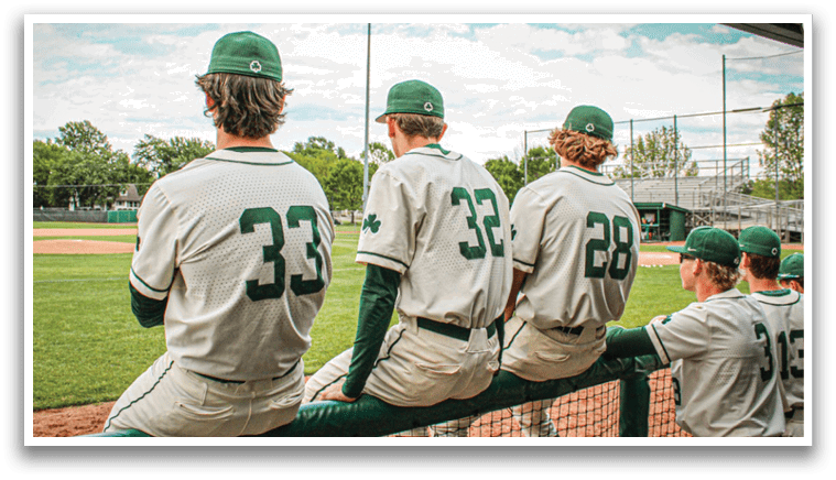 Baseball players sitting on a bench. Description generated by AI