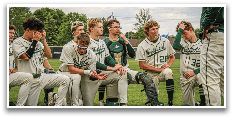 A group of baseball players sitting on the grass. Description generated by AI