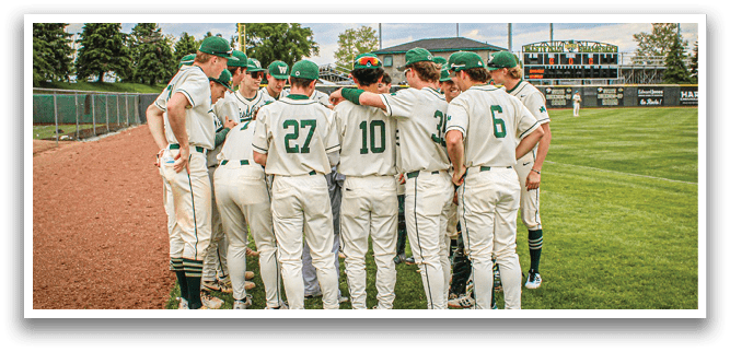 A group of baseball players wearing green and white uniforms. Description generated by AI