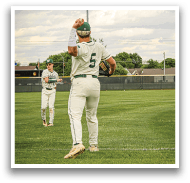 A baseball player wearing a white uniform and green sleeves is throwing a ball. Description generated by AI