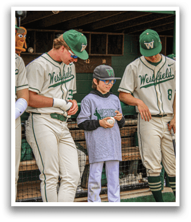 A boy wearing a grey shirt and white pants is holding a baseball. Description generated by AI