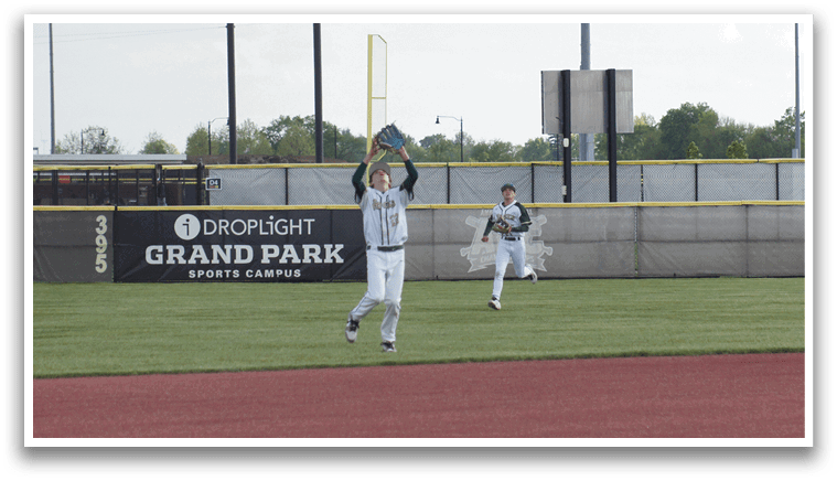 A baseball player catching a ball. Description generated by AI