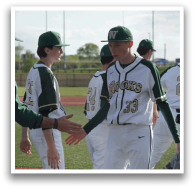 A group of baseball players wearing green and white uniforms. Description generated by AI